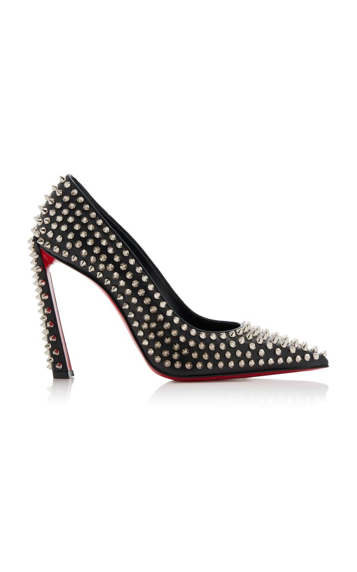 a pair of black, pointedtoe, spiked heels with a stiletto heel. the heels are studded with silver spikes and have a red leather sole. the shoes are elegant and stylish and would be perfect for a night out.