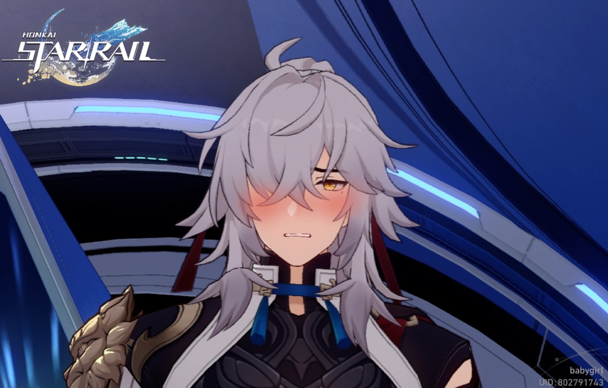 a closeup shot of a male anime character from the video game honkai: star rail. he has silver hair and blue eyes and is blushing. he is wearing a black and white outfit with a white collar.  the background is a dark blue and grey futuristic setting.  the image is an illustration of a fictional character from a video game.