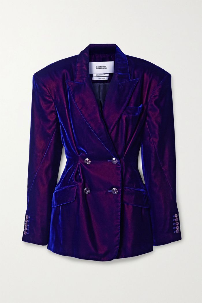 a frontfacing shot of a purple velvet doublebreasted blazer with lapels, pockets, buttons, and shoulder pads.
