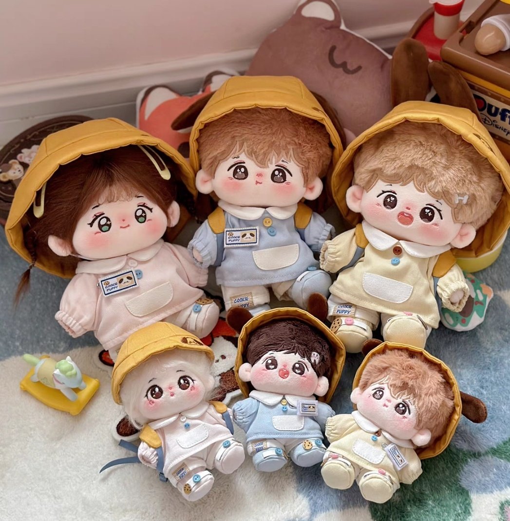 a group of adorable plush toys in school uniform outfits are sitting together. they are all wearing cute hats and smiling happily. the dolls have big eyes and rosy cheeks, and they are dressed in a variety of colors. one doll is wearing a pink uniform, while another is wearing a blue uniform and a yellow one. they are all posed in a way that suggests they are playing together. the image is full of joy and happiness, and it is sure to bring a smile to anyone's face.