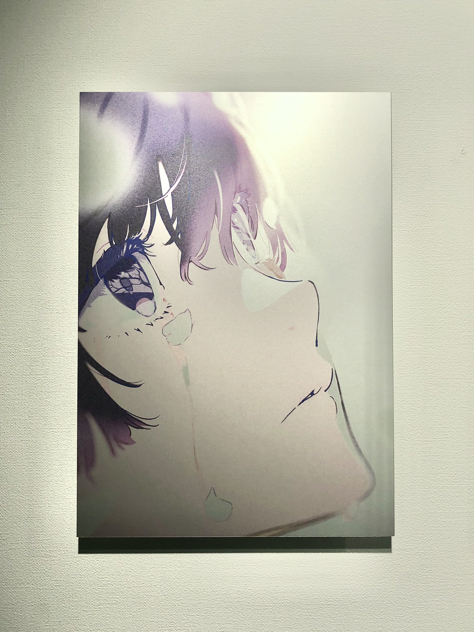 a digital art print of a young woman with dark hair and large eyes. she has a melancholic expression and a single tear running down her cheek.  the background is a soft, blurred gradient of light colors.