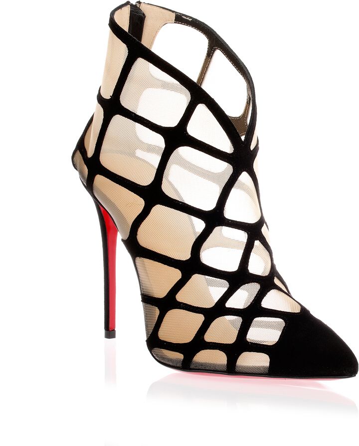 the image shows a pair of christian louboutin women's ankle boots. the boots are black suede with a mesh cutout design.  they have a pointed toe and a very high stiletto heel with the characteristic red sole.  the boots are presented on a white background, with a slight reflection visible below. the style is elegant and sophisticated.