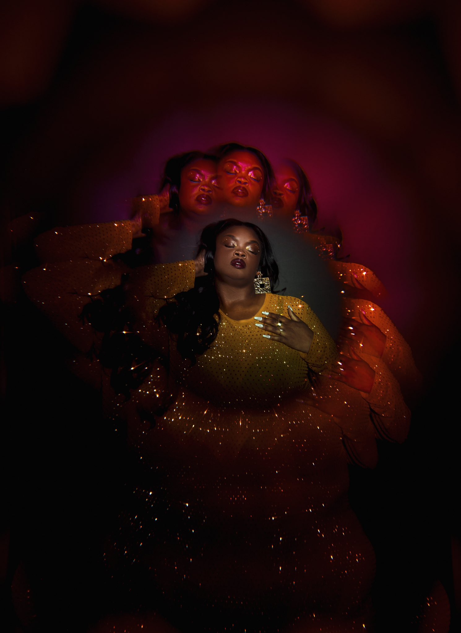 a woman in a yellow sequin dress poses against a dark background with red lighting. her pose is sensual and dramatic, creating a glamorous feel. the lighting and her pose are suggestive of a studio setting.  the woman is wearing jewelry and her hair is styled in a way that is both glamorous and modern.  the image is a captivating and stylized portrait of a glamorous woman.