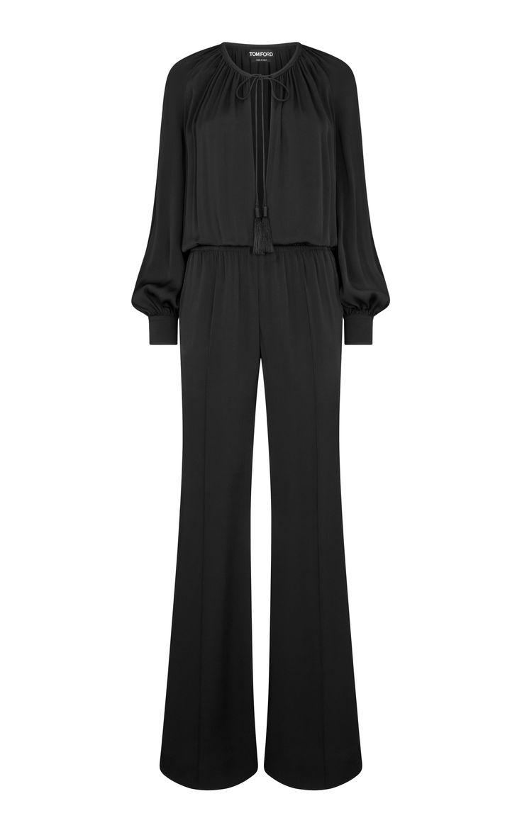 a black, longsleeved jumpsuit with a wide leg and a tie at the front. the jumpsuit is made of a silky material.