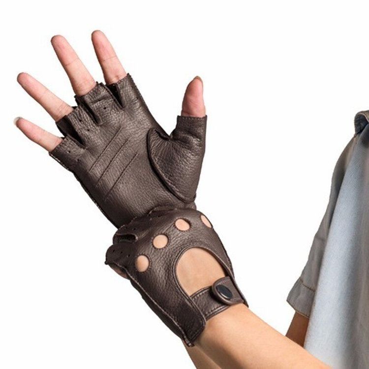 a person is wearing brown leather fingerless gloves. the gloves are made of brown leather and have a perforated design. the person is wearing the gloves on their right hand. the gloves are extended to their wrist. the person is wearing a light blue button up shirt.  they have their right hand up as if they are waving.  the image is taken from a slightly low angle.