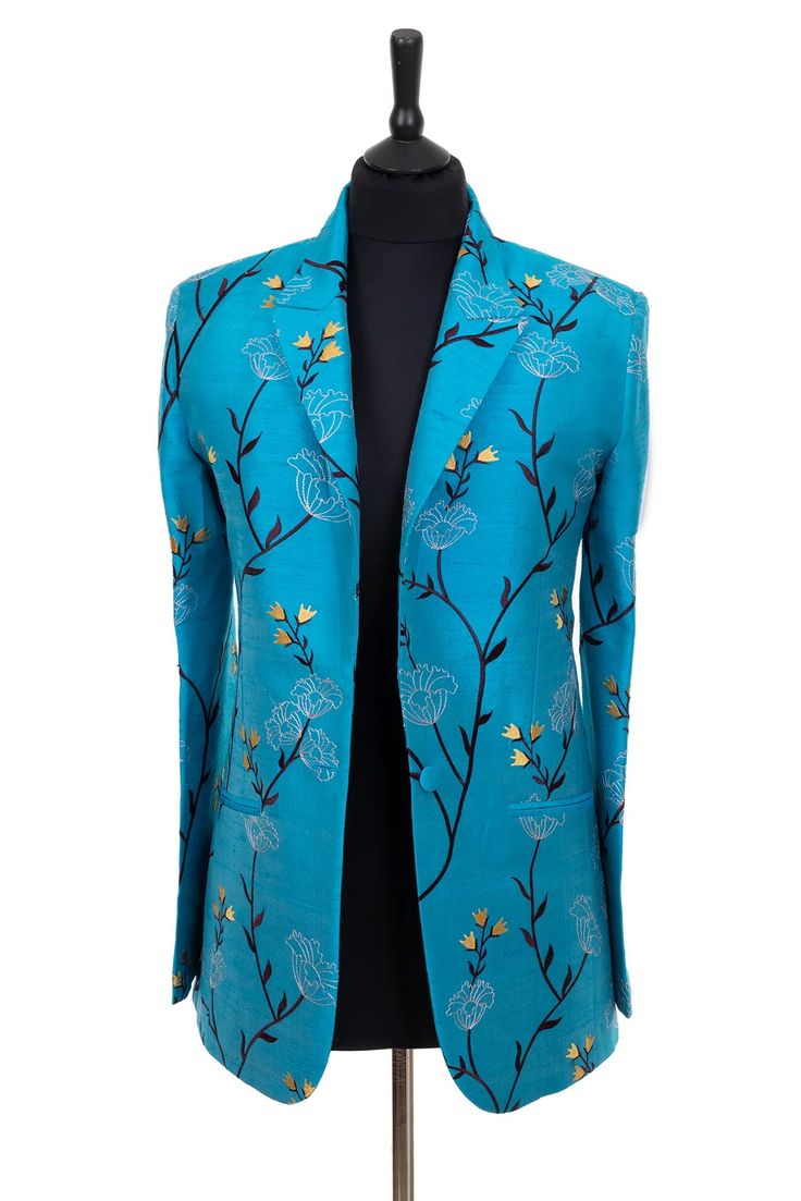 a teal blue men's blazer with embroidered flowers and gold accents. the blazer has a single button closure and a classic lapel. the blazer is displayed on a mannequin.