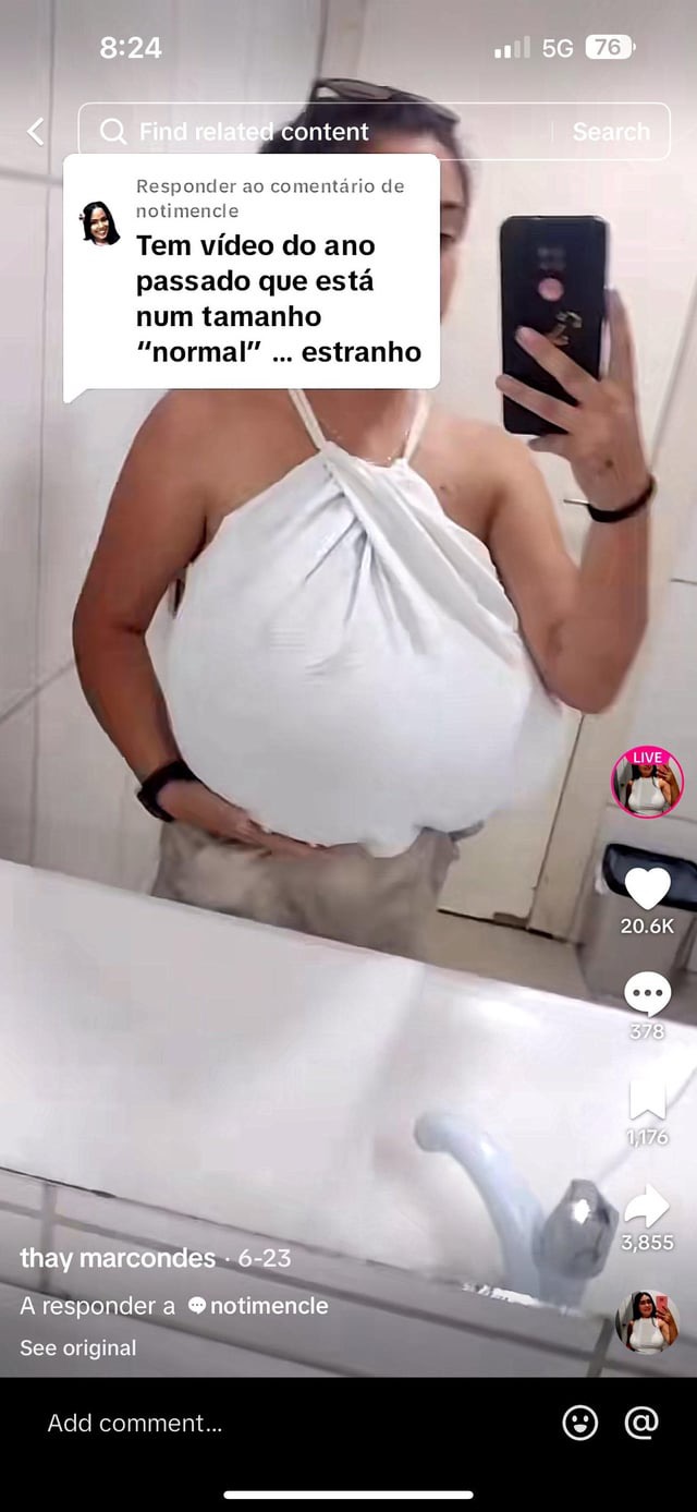 a woman is taking a selfie in a bathroom. she is wearing a white bra and is standing in front of a mirror. the woman's chest is very large.  in the background, you can see a toilet, a shower, and a sink.  she is talking about a video she saw on social media that made her feel uncomfortable. the caption reads "strange."