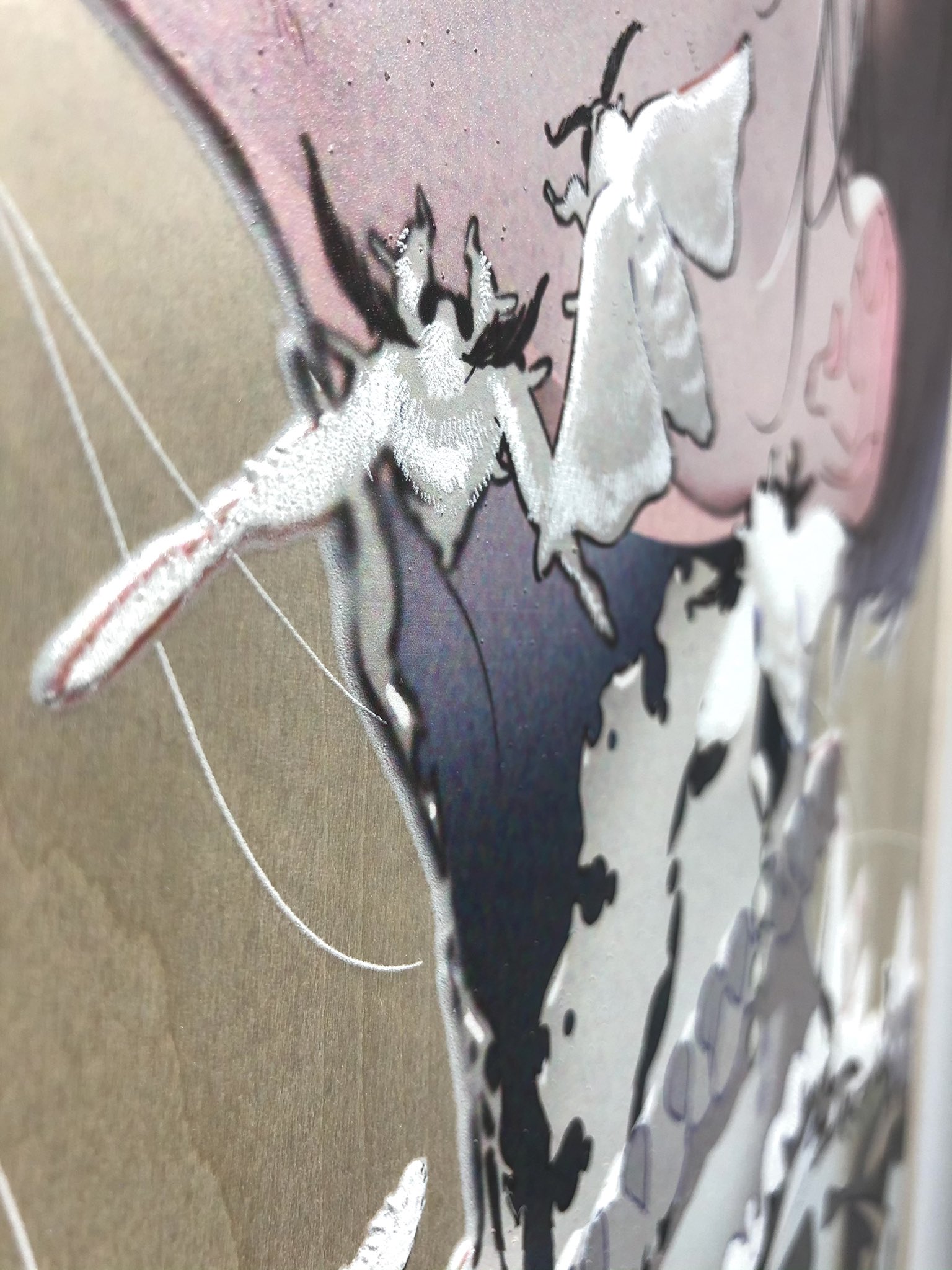 a closeup image featuring silver leafing in an abstract design that resembles a moth over a figurative painting.