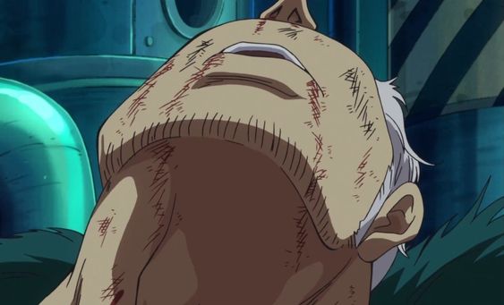 a heavily scarred and bloodied man, seemingly defeated in battle, lies on his back, his face turned upwards. the perspective is from below, emphasizing the man's vulnerability and the severity of his injuries. the setting appears to be industrial, with metallic structures and pipes in the background. the lighting is predominantly cool and shadowy, further enhancing the grim atmosphere.