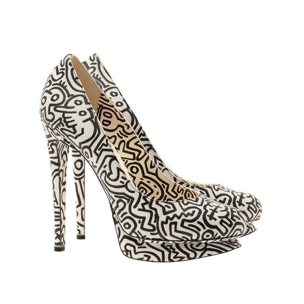 a pair of black and white high heeled platform shoes. the shoes are covered in a black and white abstract print. the heels are very high and stiletto. the shoes are very stylish and elegant.