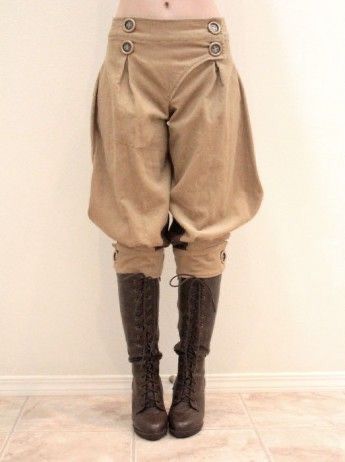 a full shot of a person wearing beige highwaisted breeches with button detailing and brown laceup kneehigh boots. the pants are styled in a retro or steampunk fashion, with a slightly puffy, loose fit. the boots are dark brown leather, laced up the front, and have a slight heel. the overall look is autumnal and vintageinspired. the background is a plain, lightcolored wall and floor.