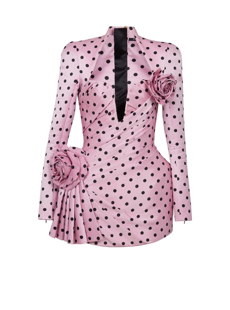 a pink mini dress with black polka dots, featuring long sleeves, a high neck, and rose embellishments.