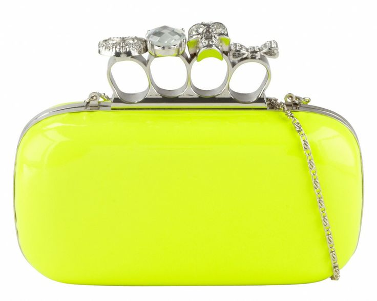a neon yellow clutch handbag with a silver ring clasp featuring skulls and gems. a silver chain is attached to the side.