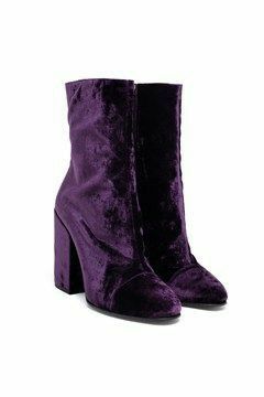 a pair of purple velvet ankle boots with a block heel. the boots are shown against a white background.