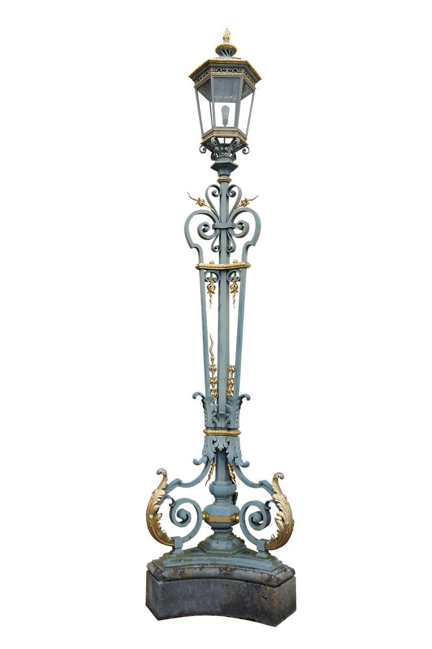 a tall, ornate light pole with a blue and gold color scheme stands against a black background. the pole has decorative metalwork, including scrolls and flourishes, and is topped with a lamp. the base of the pole sits on a stone or concrete foundation.