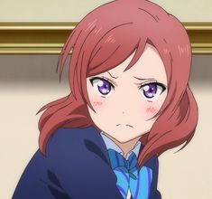 an anime girl with red hair and purple eyes, blushing slightly, wearing a blue and white school uniform. the image is a closeup portrait. the background is a golden framed picture.