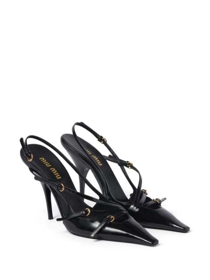 a pair of black miu miu heels with pointed toes, straps, and buckles. the shoes are made of leather and have a high heel. the shoes are on a white background.