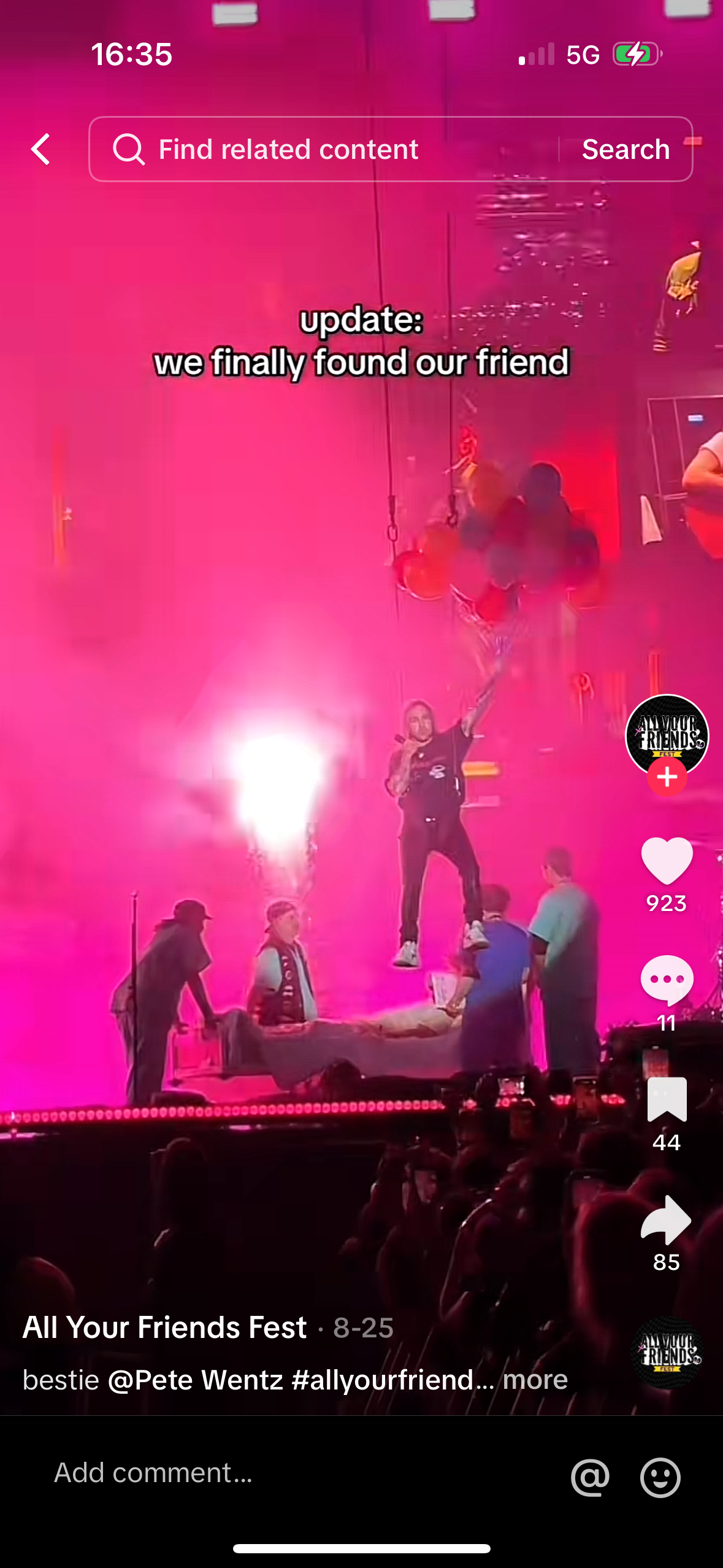 a concert stage with a band playing. the singer is in the center, holding a microphone. the band is surrounded by a crowd of excited fans. the image is brightly lit with pink and purple lights. the text "update: we finally found our friend" is displayed at the top of the image. the caption reads "all your friends fest 825 bestie @pete wentz #allyourfriend...more." the image conveys a feeling of excitement and joy.