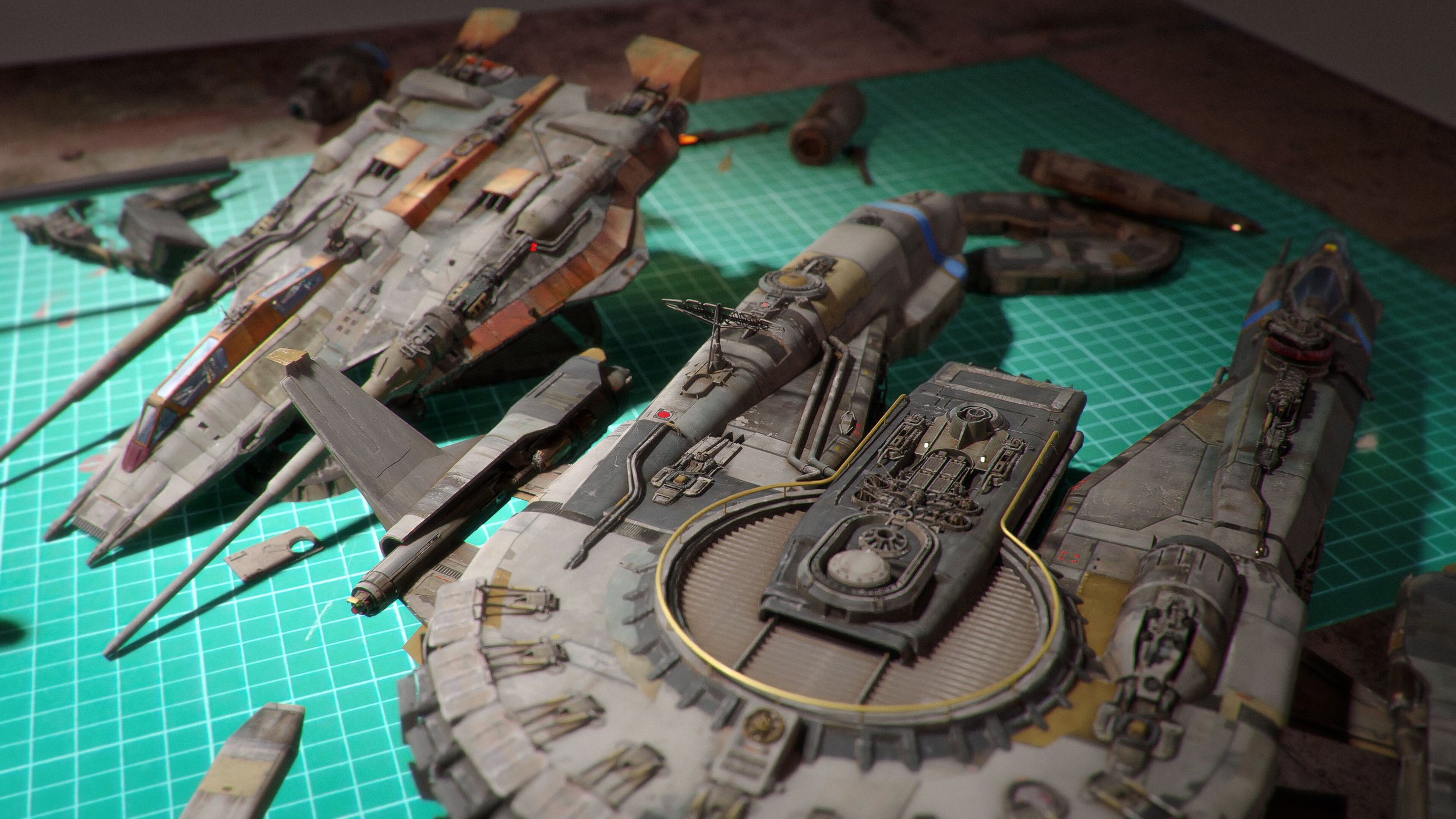 a closeup shot of two detailed model spaceships in various stages of assembly. the models are predominantly grey and brown with hints of orange and metallic accents, showcasing weathering and wear.  they rest on a green cutting mat alongside scattered small parts, suggesting a workinprogress on a workbench or similar crafting surface. the scene is dimly lit, highlighting the intricate details of the models. one spaceship appears almost completed while the other is still in pieces, showing different levels of construction. the overall impression is a hobbyist's workspace dedicated to the meticulous creation of scifi model spaceships.