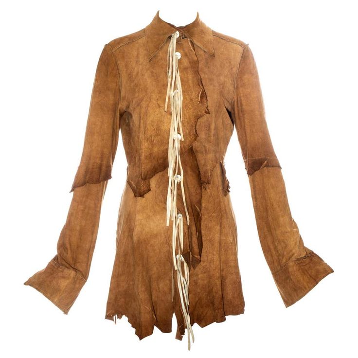 a brown suede jacket with fringe detailing. the jacket has a vintage look and is made of soft leather. the fringe is a popular feature of boho chic style.  the jacket would be a great addition to any wardrobe and would be perfect for dressing up a casual look.