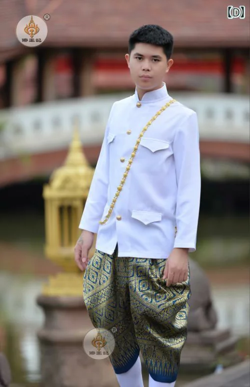 a young, handsome man in traditional thai clothing. he is wearing a white shirt with gold trim and a pair of gold and blue pants. he is smiling at the camera and looks very elegant.