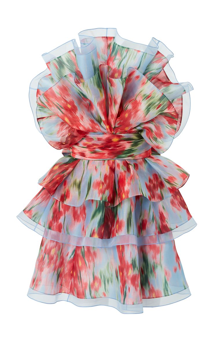 a closeup image of a short, flowy dress with a floral print in shades of red, pink, and light blue. the dress has a layered, ruffled skirt and a fitted bodice. it is made of a light, semitransparent fabric that gives it a delicate and airy feel. the dress is perfect for a summer or spring occasion.