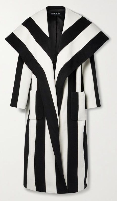 the image shows a kneelength coat with a striking black and white striped pattern. it has a shawl collar, long sleeves, and pockets. the coat appears to be an overcoat or outerwear garment.