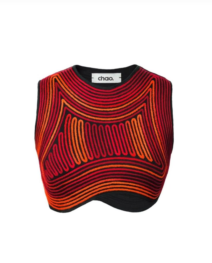 a closeup shot of a sleeveless top with a black base and intricate red and orange patterns. the patterns consist of curved lines and geometric shapes, creating a unique and eyecatching design. the top has a label that says "chao."