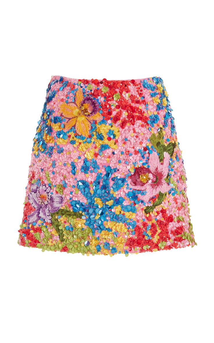 a pink mini skirt with colorful floral embroidery and sequins.