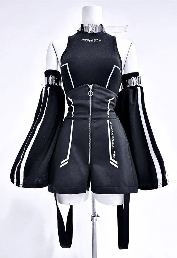 the image shows a black and white futuristic outfit on a mannequin. the outfit consists of a highwaisted shorts and a halter top, both with white stripes and text details. the sleeves are long and wide, with white stripes along the sides. the outfit is accessorized with a black belt, harness and silver buckles. the mannequin is posed on a stand against a white background. the overall style is cyberpunk and edgy.