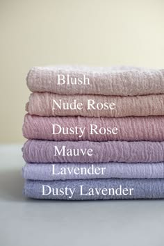 a stack of fabric swatches labeled with the following colors: blush, nude rose, dusty rose, mauve, lavender, dusty lavender. the swatches are all in soft, muted pastel colors.