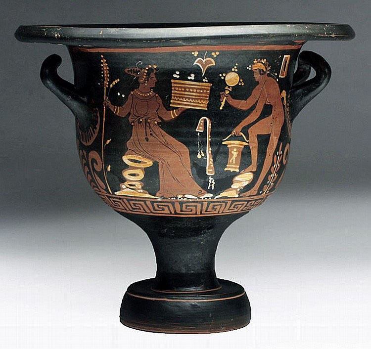 this image shows an ancient greek redfigure kylix, a type of drinking cup.  the vase is black with a redfigure painting depicting a scene likely from greek mythology. two figures, a seated woman (possibly a goddess) and a standing man (possibly a god), are centrally featured, interacting with various objects including what appears to be a box or container, and other ritualistic items.  the figures are painted in reddishbrown against the black background.  ornamental details, including a meander pattern (greek key) near the base, further enhance the aesthetic quality. the kylix stands on a foot and has two handles. the overall condition appears wellpreserved considering its age.
