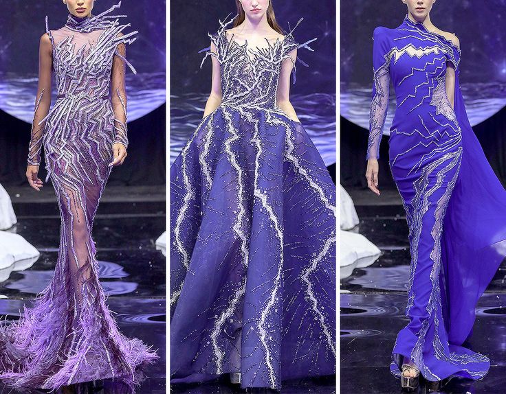 three fashion models showcasing three different styles of blue and purple evening gowns on the runway. the dresses are embellished with silver sequins, beads, and intricate embroidery, adding a touch of sparkle and glamour. the models exude confidence and elegance as they walk down the catwalk. the lighting and backdrop enhance the overall mood of the fashion shoot.