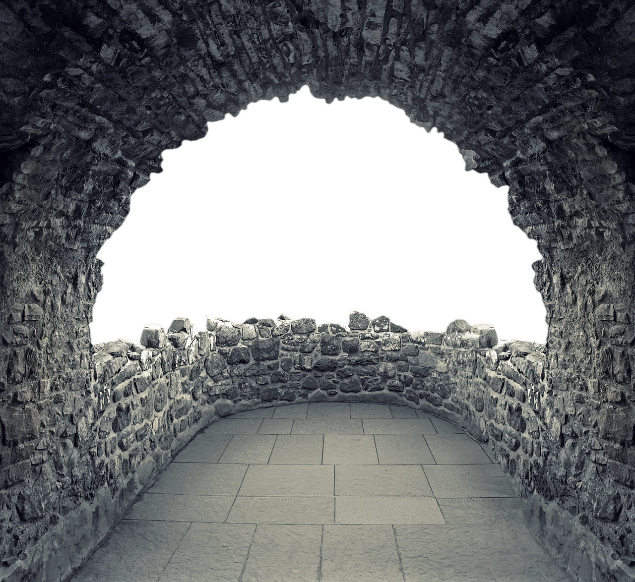 a black and white image of a stone tunnel with an arched opening leading into darkness. the walls and floor are made of stone, giving the impression of a medieval structure.