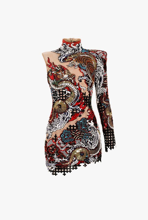 a closeup shot of a designer mini dress with orientalstyle embellishments. the dress is asymmetrical with one long sleeve and a high neckline. it features a sheer mesh base decorated with intricate sequin designs of a dragon and a tiger, along with other orientalinspired motifs. the dress is trimmed with black at the edges.