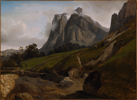 a landscape painting features a prominent mountain range with snowcapped peaks shrouded in clouds under a cloudy sky. green hills and valleys are in the foreground, with a winding path visible along the hillside. a stone bridge crosses a rocky stream in the lower left corner of the painting. the painting captures a serene and majestic view of the natural landscape.
