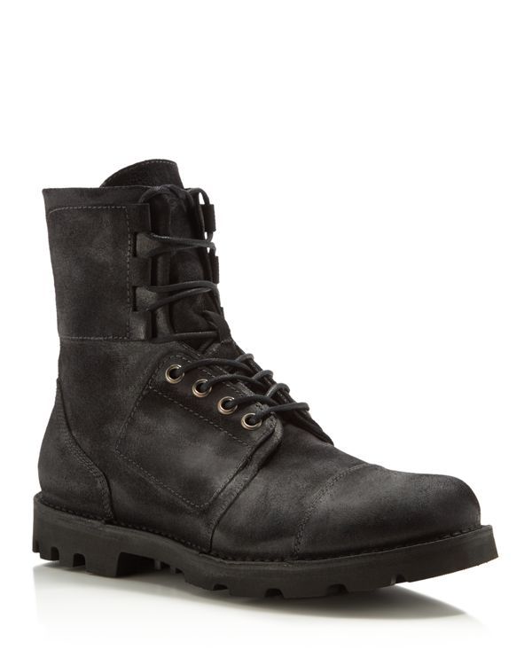a pair of black leather combat boots with laces and a rugged sole. the boots are worn and have a distressed look. the boots are made of highquality leather and are durable and stylish. they are perfect for casual wear and can be paired with jeans or chinos.