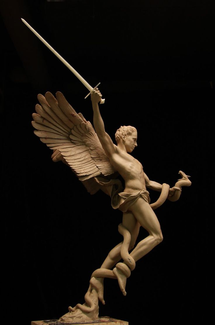 a clay sculpture of a winged man, possibly an angel, with a sword raised in his right hand. his left hand holds a snake that is wrapping itself around his legs. the sculpture is set against a black background.