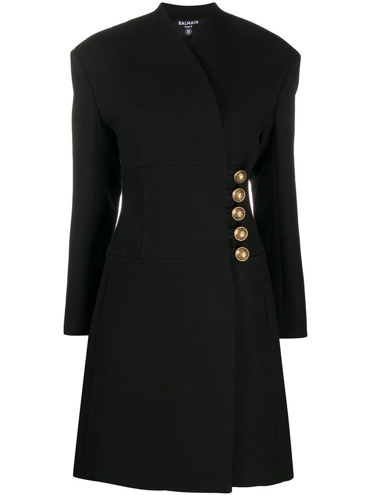 a black balmain mini dress with long sleeves, a vneck, and gold buttons.