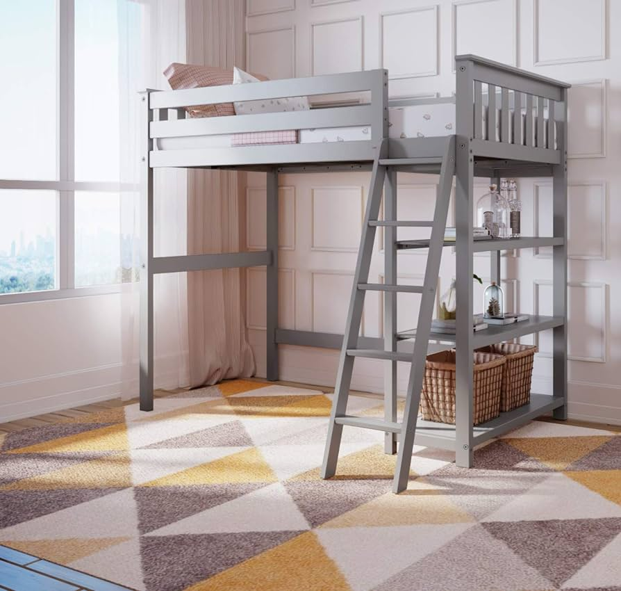 the image shows a gray loft bed with a builtin ladder and shelves. the bed is in a room with white walls and a large window. there is a yellow and gray rug on the floor. the room is welllit with natural light.