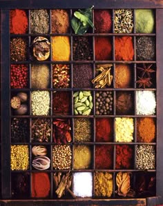a vintage wooden box filled with an assortment of spices and herbs. the box has many small drawers, each containing a different type of spice or herb. the spices and herbs are a variety of colors, including red, brown, yellow, green, and white. they are arranged in a visually appealing and organized manner, highlighting the diversity and beauty of culinary ingredients. the image evokes a sense of warmth, comfort, and the rich history of spices and their role in cooking and flavoring food.