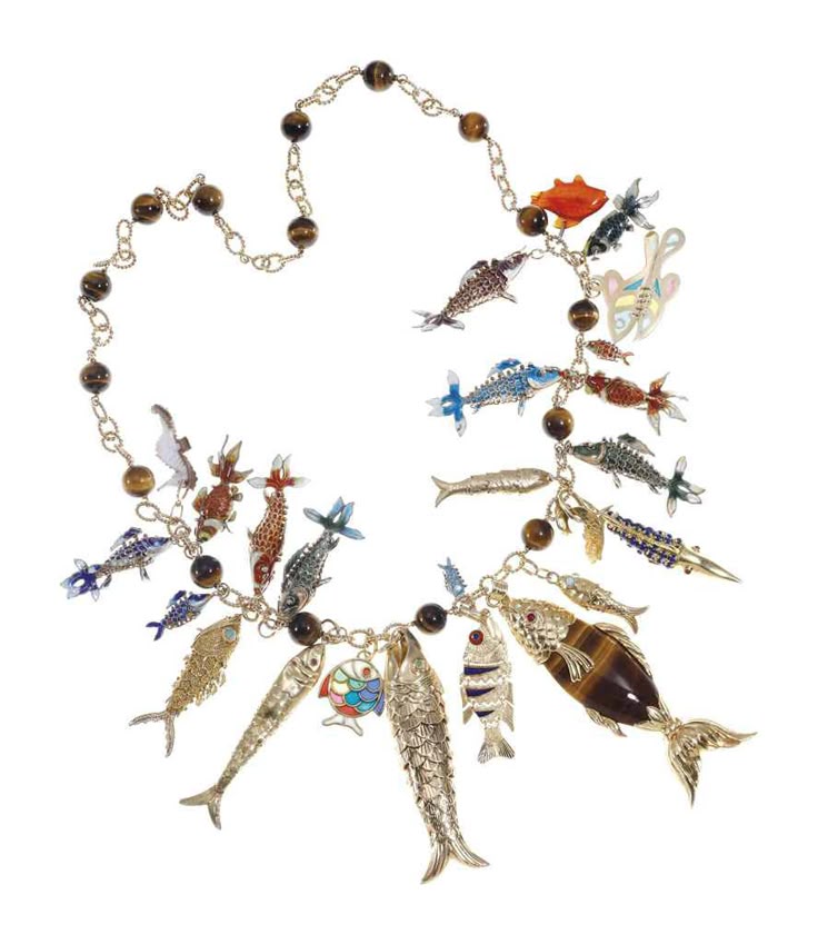 a necklace with a gold chain and brown beads is adorned with various fish charms made of metal, enamel, and tiger's eye stone. the fish charms vary in size, color, and design, creating a whimsical and ornate piece of jewelry.
