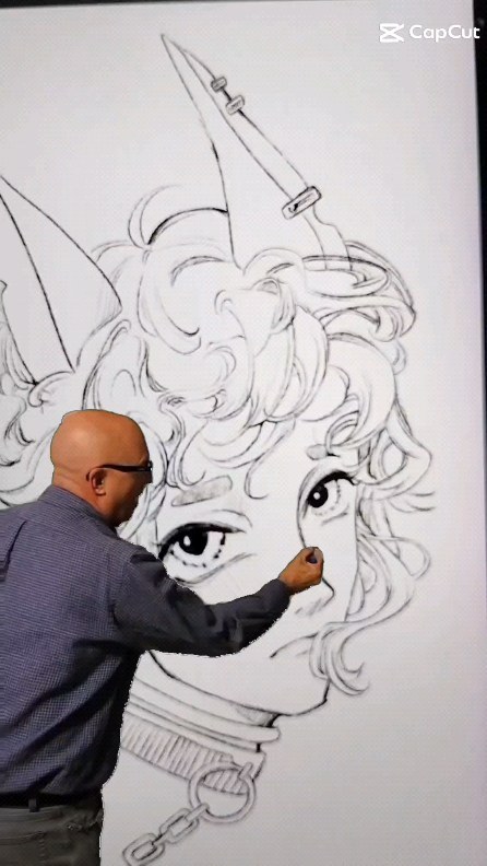 an artist is meticulously adding charcoal detail to a largescale drawing of a woman with animestyle features, including horns and a collar with a chain. the artist is shown from the back, focusing intensely on his work.  the drawing is predominantly black and white and fills a large portion of the wall behind the artist. the overall style of the art is reminiscent of manga or anime. the image is a snapshot of the artistic process, highlighting the precision and detail involved in creating the artwork.