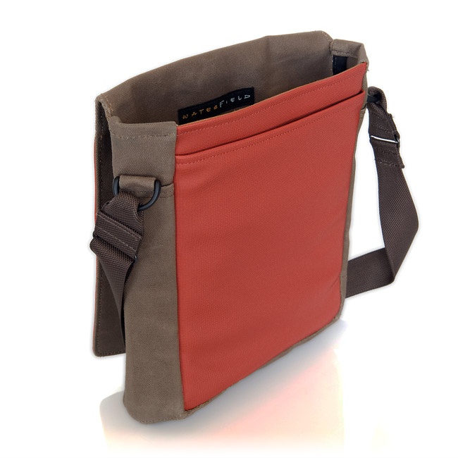 a brown canvas messenger bag with a red flap pocket. the bag has a brown strap and a zipper closure. the bag is made by waterfield and is perfect for carrying everyday essentials.
