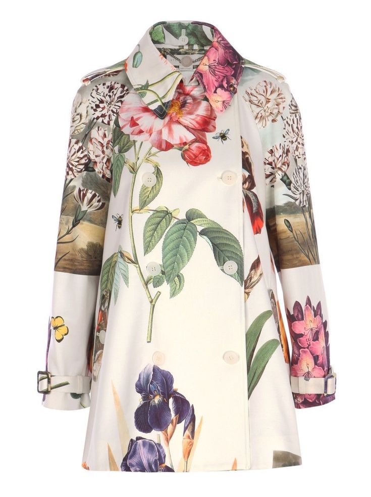 a doublebreasted trench coat with a floral and botanical print on a light background. the coat has a collar, sleeves with cuffs, and is buttoned up.