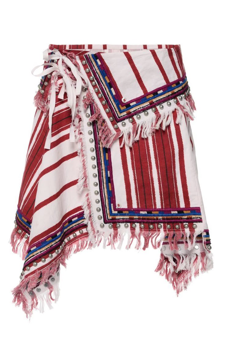 a red and white striped asymmetrical wrap skirt with tassels, fringe, and silver stud detailing. the skirt has a tie closure and a bohemian or ethnic style.