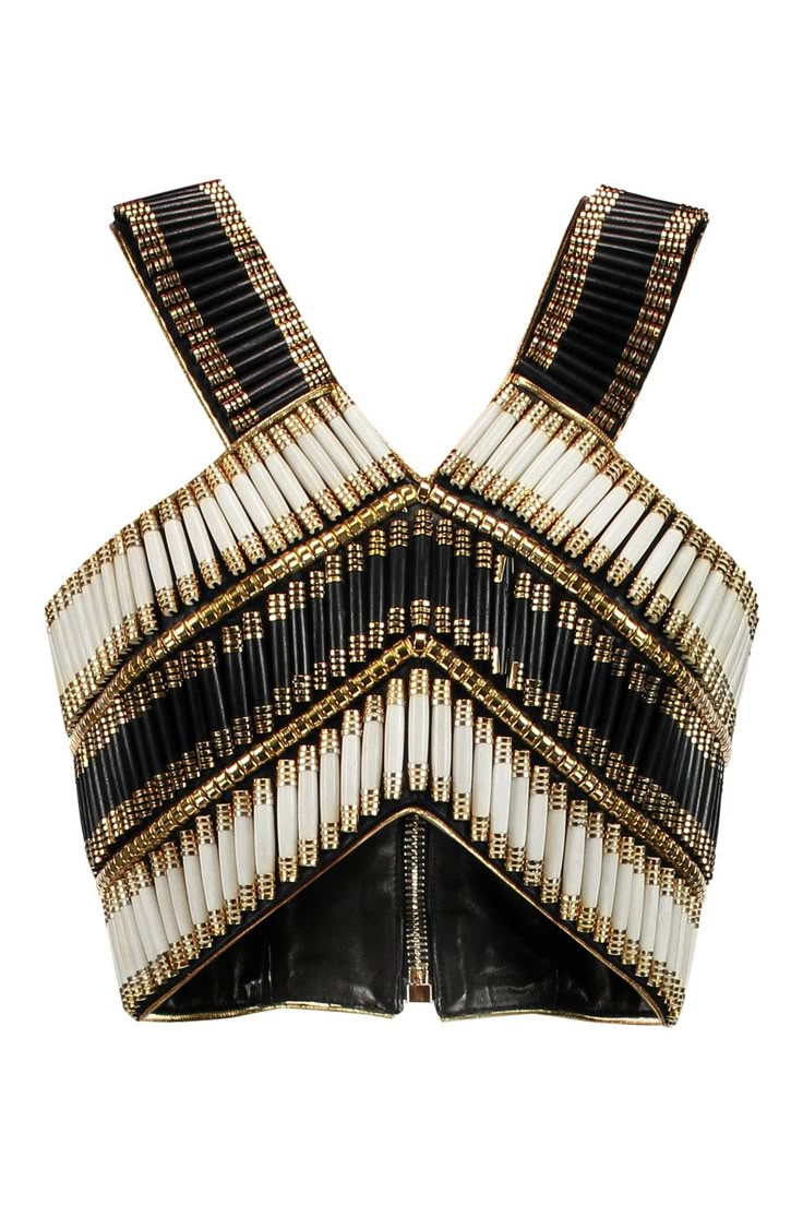 an overhead shot shows a cropped beaded bustier top. the sleeveless top features crisscross straps and is adorned with rows of black, white, and gold beads arranged in geometric patterns. a zipper runs vertically down the center.