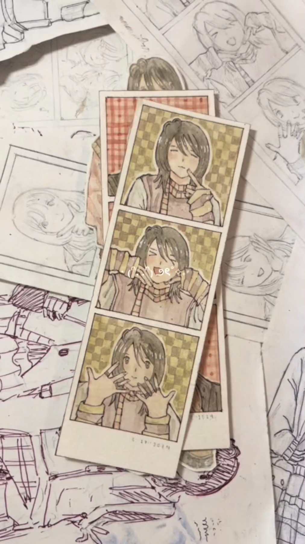 a closeup image of a collection of drawings. there are multiple drawings of anime style characters. the characters are drawn in a variety of poses.  the style of the drawings is light and airy.