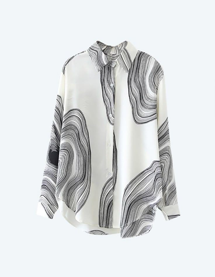 a longsleeved white collared shirt with black wavy patterns on it. the shirt is unbuttoned and the patterns appear like curved lines in varying thicknesses.