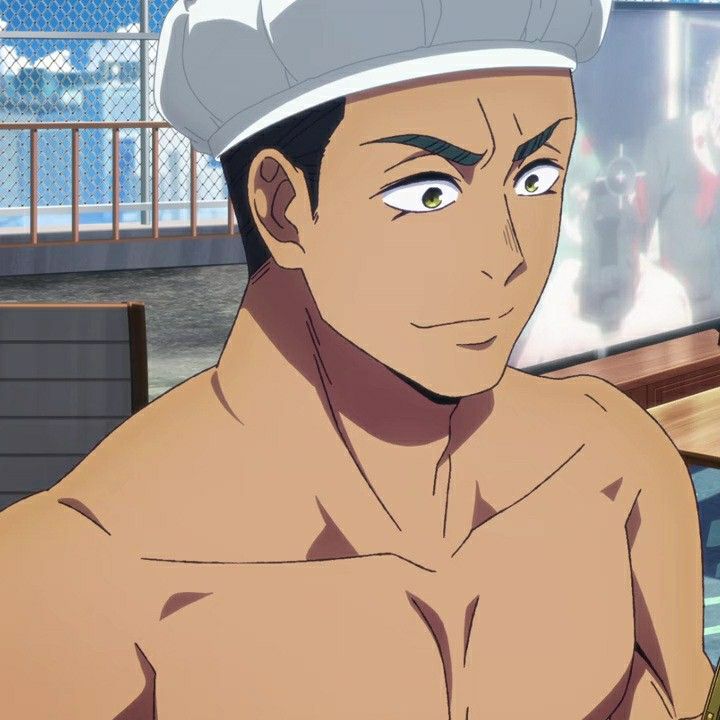 a close up shot of a young man with brown skin and dark hair, wearing a white chefs hat. he looks like he's in a relaxed mood.  the background is blurry and shows a view of an outdoors setting.
